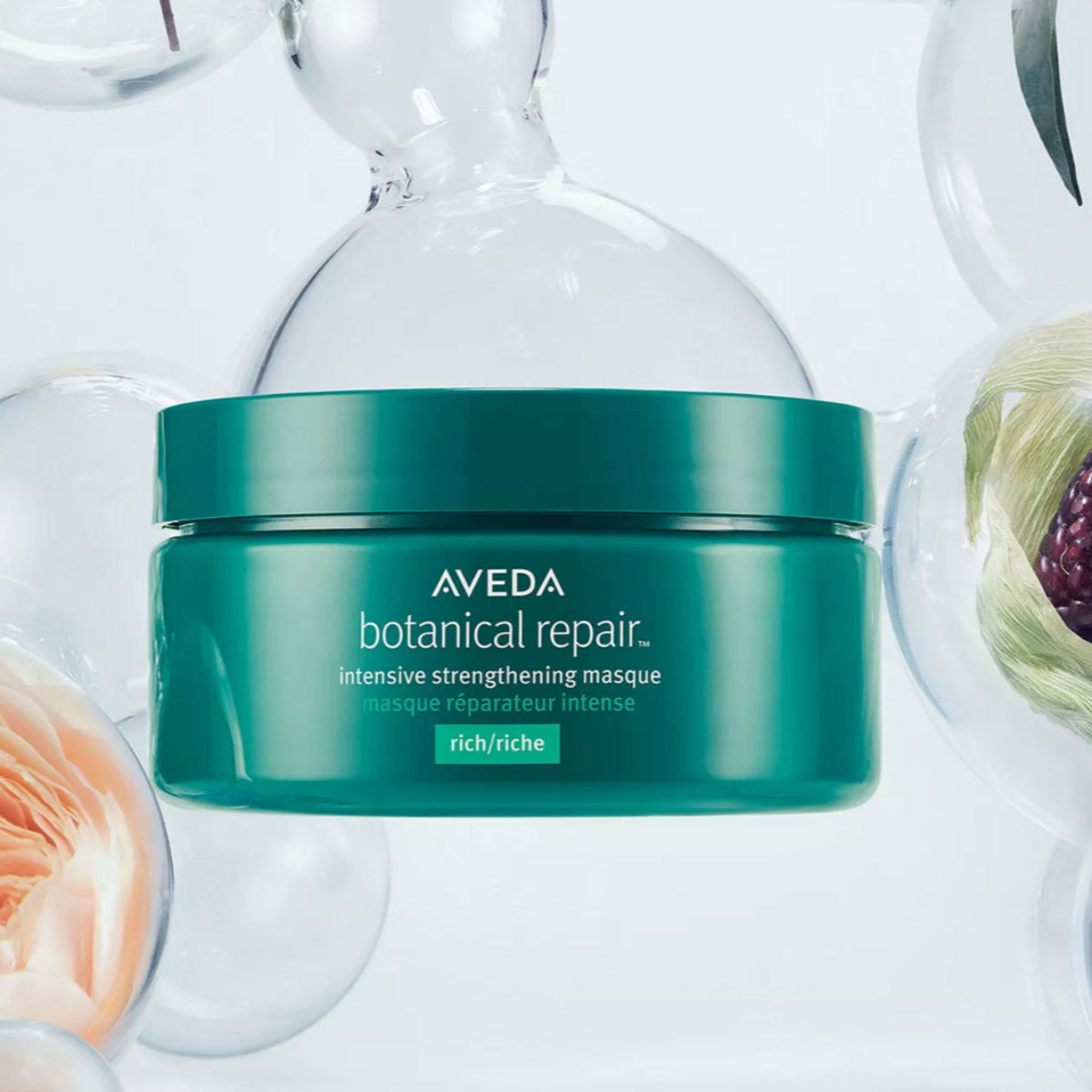 Aveda botanical repair jar on a white background with decorative elements